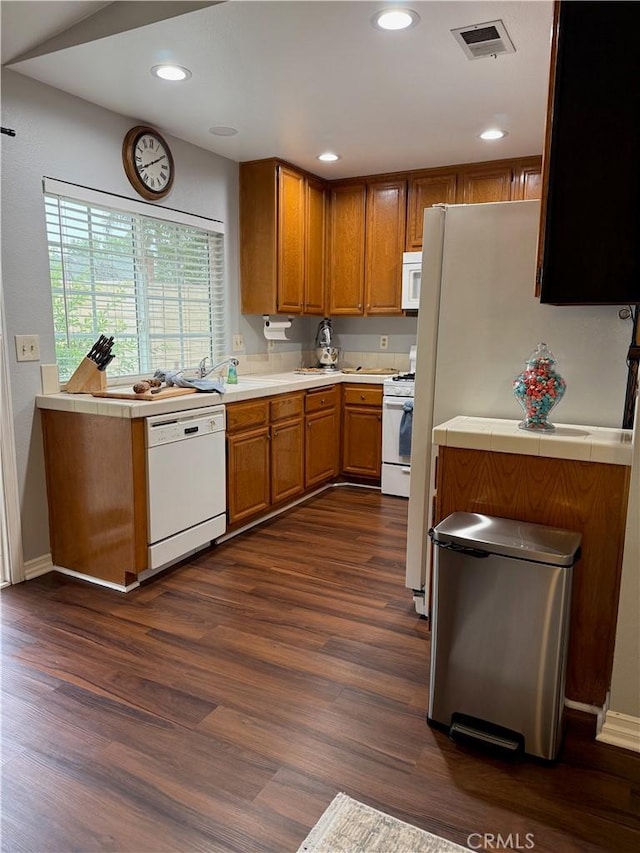 2579 Oak Springs Pl, Ontario, CA 91761 - kitchen with white appliances, brown cabinets, tile countertops, dark wood-style flooring, and recessed lighting