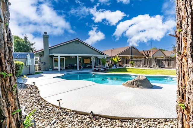 view of swimming pool featuring a lawn, a patio, a fenced in pool, and fence private yard