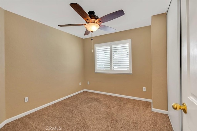 spare room with baseboards, carpet, and ceiling fan