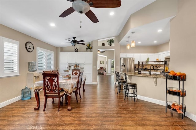 dining area with dark wood finished floors, a ceiling fan, and a healthy amount of sunlight