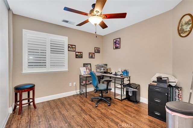 office space with wood finished floors, visible vents, baseboards, and ceiling fan