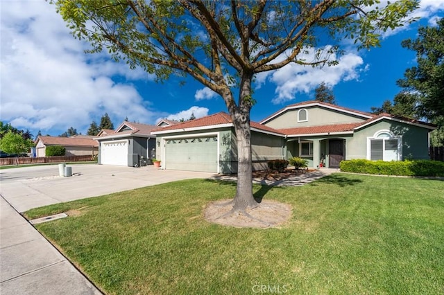view of front facade featuring driveway, fence, a garage, a front yard, and stucco siding