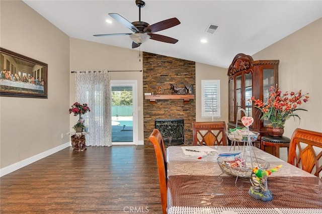 dining area featuring vaulted ceiling, visible vents, baseboards, a ceiling fan, and wood finished floors
