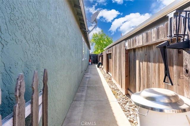 view of home's exterior with fence and stucco siding