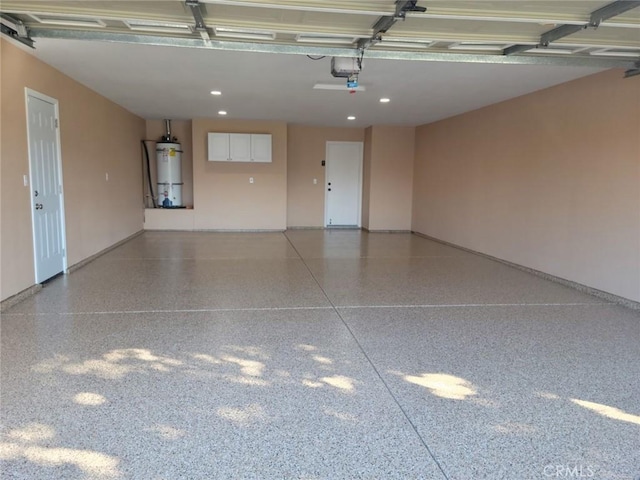 garage featuring baseboards, recessed lighting, strapped water heater, and a garage door opener