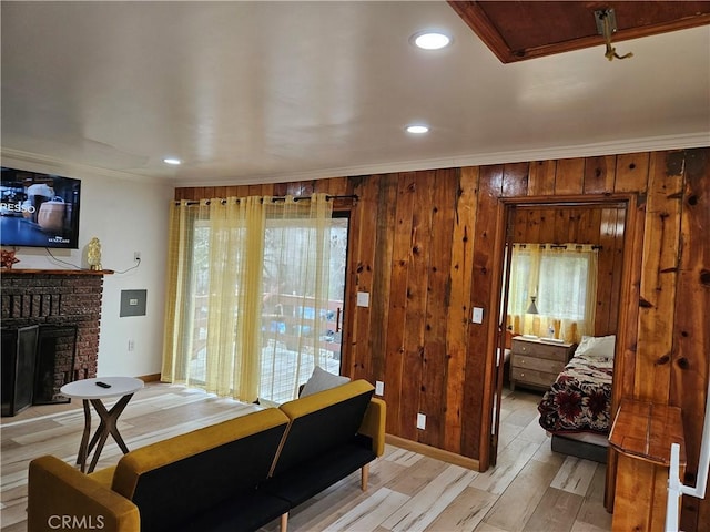 32868 Deer Ln, Running Springs, CA 92382 - bedroom featuring light wood-style flooring, a fireplace, crown molding, recessed lighting, and wooden walls