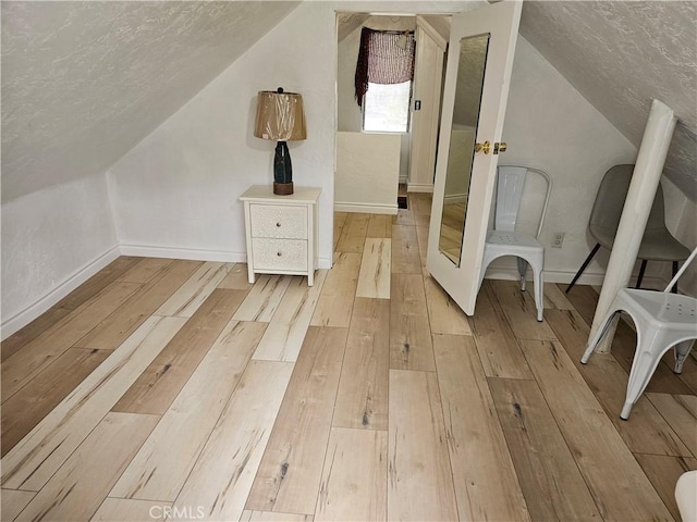 32868 Deer Ln, Running Springs, CA 92382 - bonus room featuring vaulted ceiling, a textured ceiling, and light wood-style floors