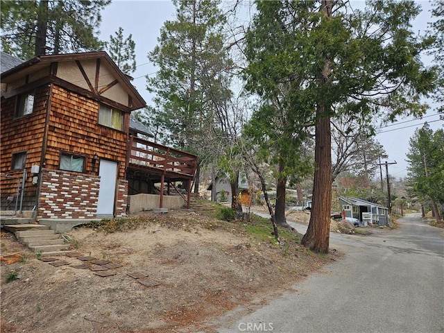32868 Deer Ln, Running Springs, CA 92382 - view of side of property featuring a deck and driveway