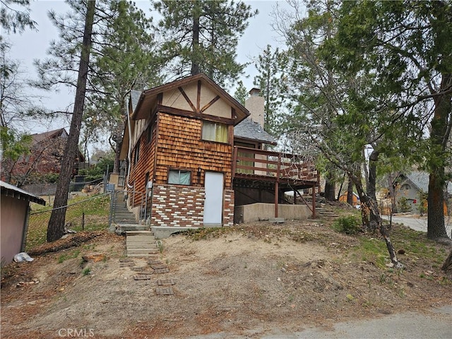 32868 Deer Ln, Running Springs, CA 92382 - back of house featuring a chimney and a wooden deck