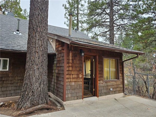 32868 Deer Ln, Running Springs, CA 92382 - doorway to property with roof with shingles and a patio area