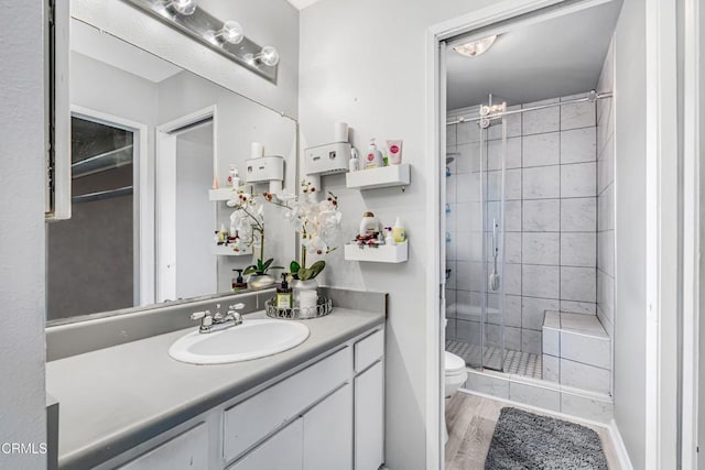 232 Prospect St, Oak View, CA 93022 - bathroom featuring a stall shower, toilet, vanity, and wood finished floors