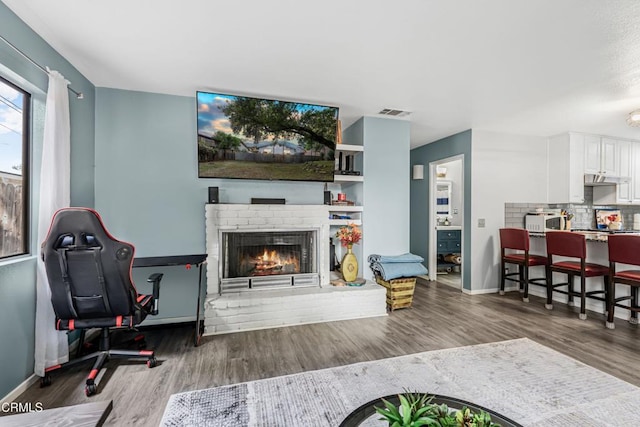 232 Prospect St, Oak View, CA 93022 - living area with wood finished floors, baseboards, and a fireplace