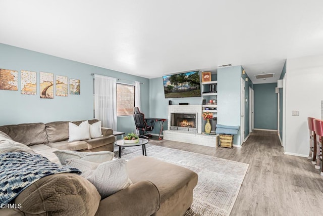 232 Prospect St, Oak View, CA 93022 - living room featuring wood finished floors, a fireplace, and baseboards