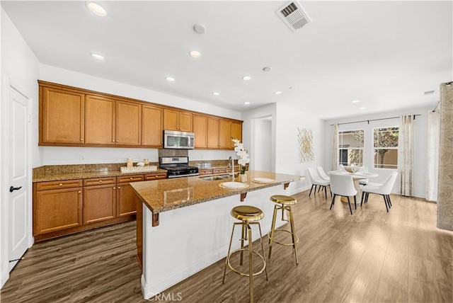 6208 Eucalyptus Ave, Chino, CA 91710 - kitchen featuring brown cabinets, visible vents, appliances with stainless steel finishes, and a sink