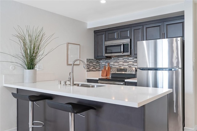 740 N Kings Rd Unit 225, West Hollywood, CA 90069 - kitchen with appliances with stainless steel finishes, a sink, a breakfast bar area, and tasteful backsplash