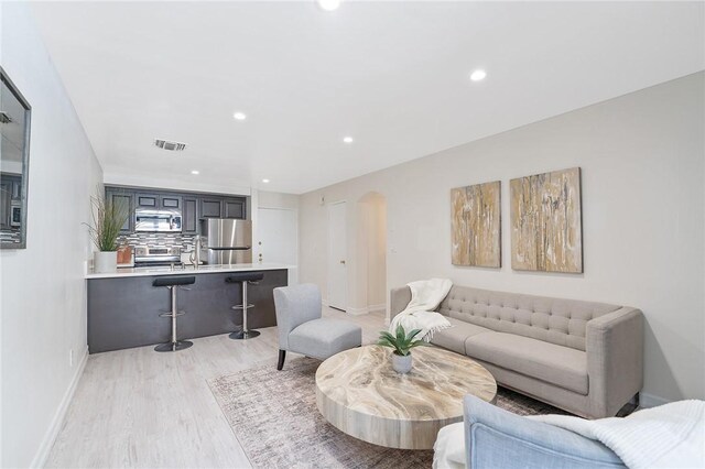 740 N Kings Rd Unit 225, West Hollywood, CA 90069 - living area with light wood-style flooring, recessed lighting, baseboards, and arched walkways
