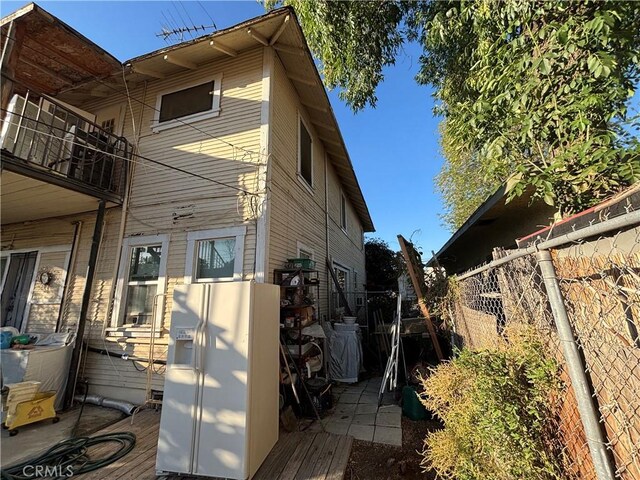 3852 4th St, Riverside, CA 92501 - view of side of home with fence and a balcony