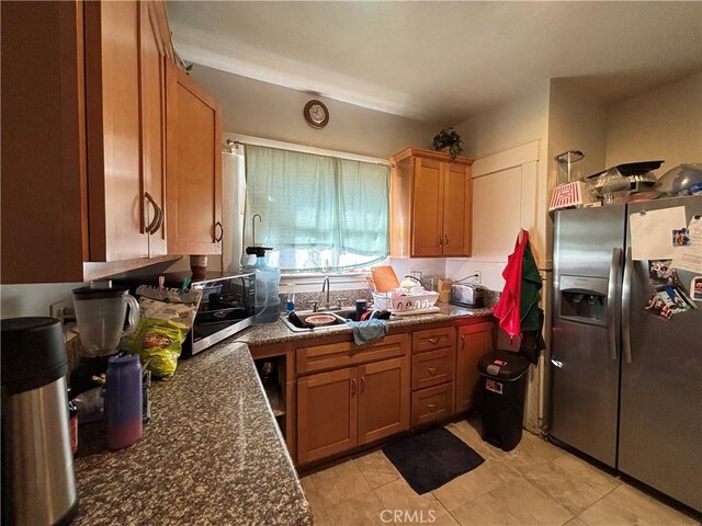 3852 4th St, Riverside, CA 92501 - kitchen with brown cabinets, stainless steel refrigerator with ice dispenser, and light tile patterned floors