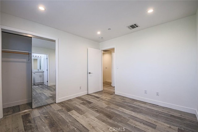 7443 Troost Ave, North Hollywood, CA 91605 - unfurnished bedroom with baseboards, wood finished floors, visible vents, and recessed lighting