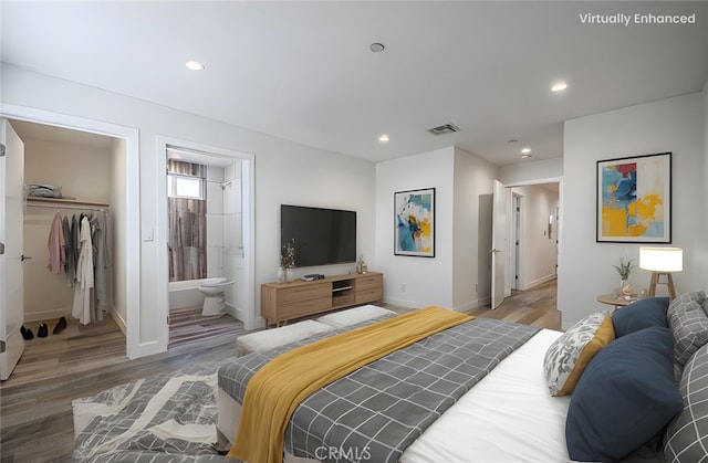 7443 Troost Ave, North Hollywood, CA 91605 - bedroom with light wood-type flooring, baseboards, visible vents, and a spacious closet