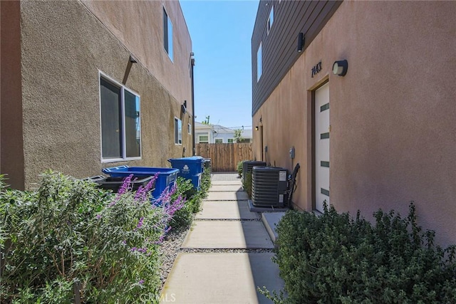 7443 Troost Ave, North Hollywood, CA 91605 - view of home's exterior featuring stucco siding, fence, and central AC unit
