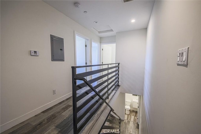 7443 Troost Ave, North Hollywood, CA 91605 - staircase featuring attic access, wood finished floors, electric panel, and baseboards