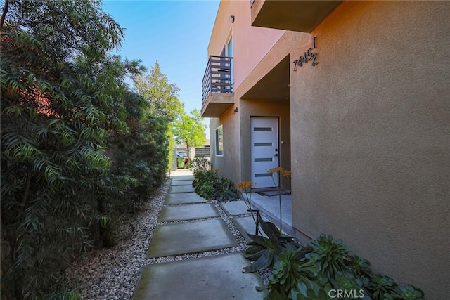 7443 Troost Ave, North Hollywood, CA 91605 - view of home's exterior with a balcony and stucco siding