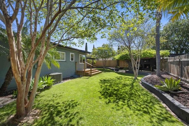 view of yard featuring a fenced backyard and central AC unit