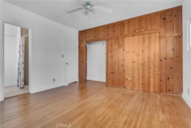 spare room featuring baseboards, a ceiling fan, and wood finished floors