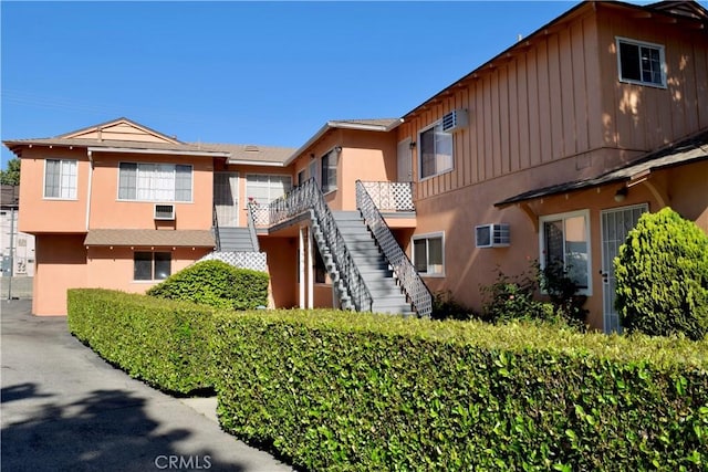 216 S Glenwood Pl, Burbank, CA 91506 - view of property with stairway and a wall mounted AC