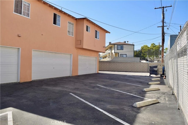 216 S Glenwood Pl, Burbank, CA 91506 - view of parking / parking lot featuring fence and an attached garage