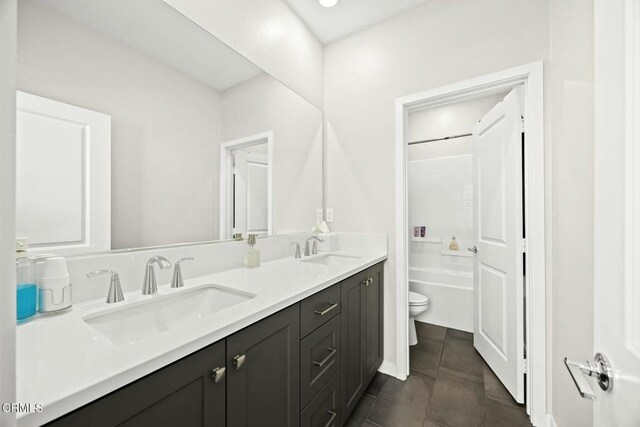 26945 Nature View Pl, Valencia, CA 91381 - bathroom featuring toilet, double vanity, tile patterned floors, and shower / bathtub combination