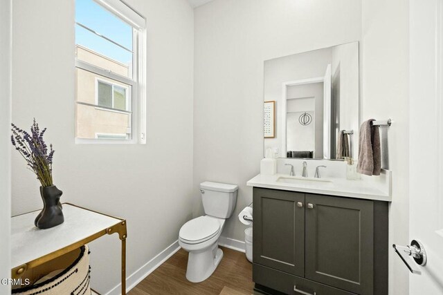 26945 Nature View Pl, Valencia, CA 91381 - bathroom with baseboards, wood finished floors, toilet, and vanity