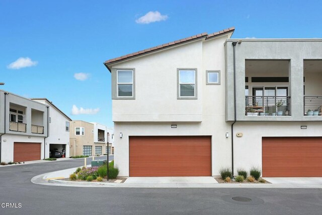 26945 Nature View Pl, Valencia, CA 91381 - view of front facade with stucco siding and a garage