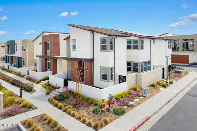 26945 Nature View Pl, Valencia, CA 91381 - view of building exterior with a fenced front yard and a residential view
