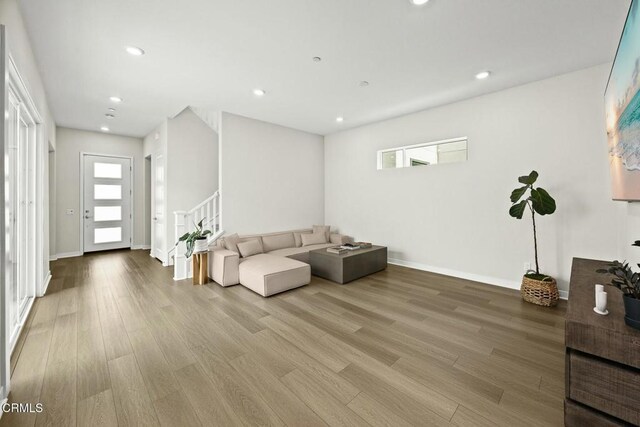 26945 Nature View Pl, Valencia, CA 91381 - living room featuring light wood-style floors, stairway, baseboards, and recessed lighting