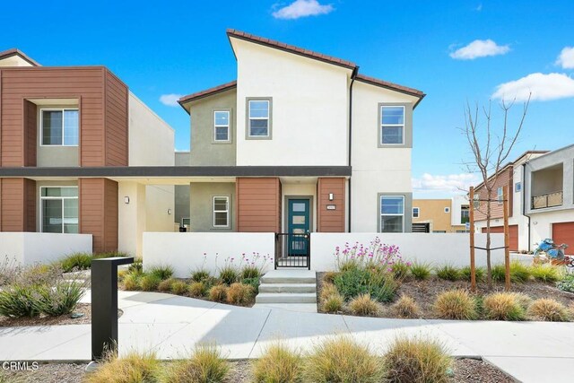 26945 Nature View Pl, Valencia, CA 91381 - view of front facade with a fenced front yard and stucco siding