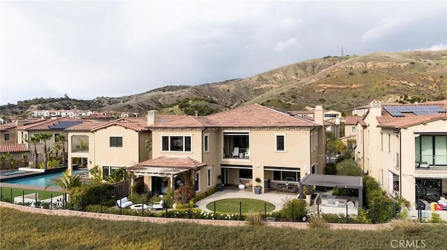 212 Clear Fls, Irvine, CA 92602 - back of house featuring stucco siding, a patio, a balcony, and a mountain view