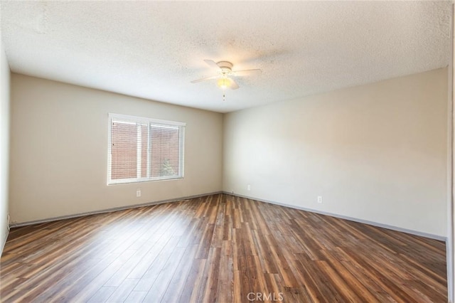 spare room featuring a textured ceiling, baseboards, a ceiling fan, and wood finished floors