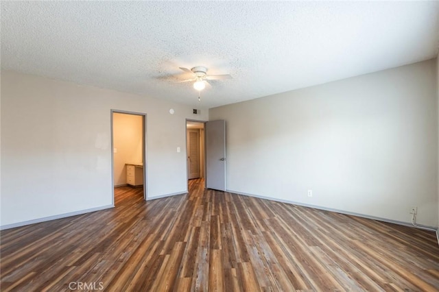 empty room with a textured ceiling, baseboards, a ceiling fan, and wood finished floors