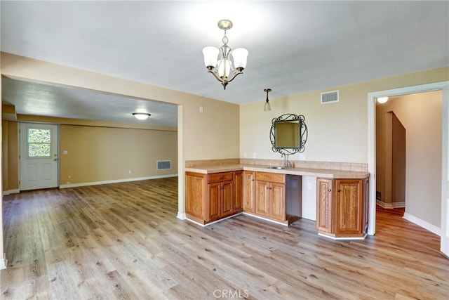 2307 Cameron Ave, Covina, CA 91724 - kitchen with light countertops, open floor plan, visible vents, and light wood-style flooring