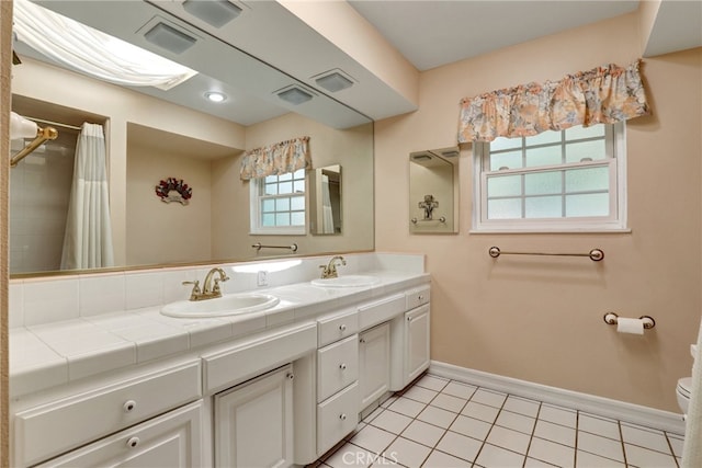 2307 Cameron Ave, Covina, CA 91724 - bathroom featuring baseboards, a sink, tile patterned flooring, and double vanity