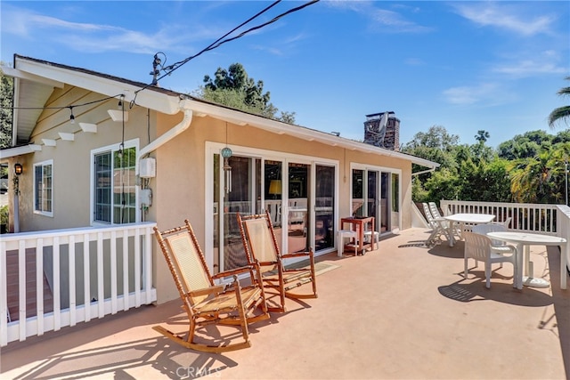 2307 Cameron Ave, Covina, CA 91724 - rear view of property featuring a chimney, outdoor dining space, and stucco siding