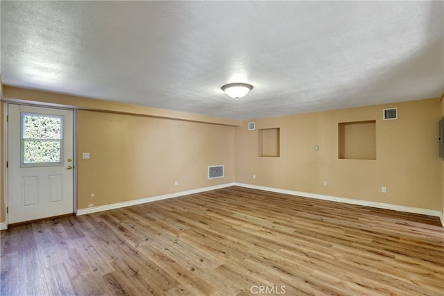 2307 Cameron Ave, Covina, CA 91724 - below grade area featuring a textured ceiling, baseboards, visible vents, and light wood-style flooring