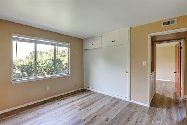 2307 Cameron Ave, Covina, CA 91724 - unfurnished bedroom featuring baseboards, visible vents, light wood-style flooring, and a closet