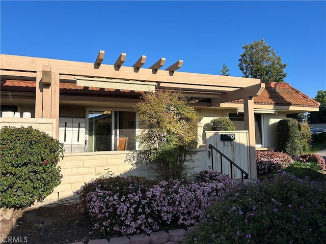 view of front of home with a pergola