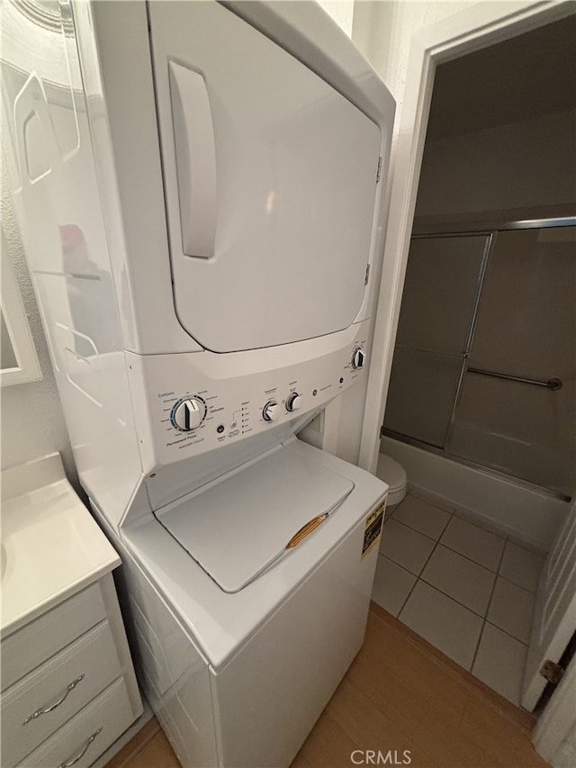 3042 Via Serena S Unit A, Laguna Woods, CA 92637 - laundry room featuring stacked washer / drying machine and light wood-style flooring