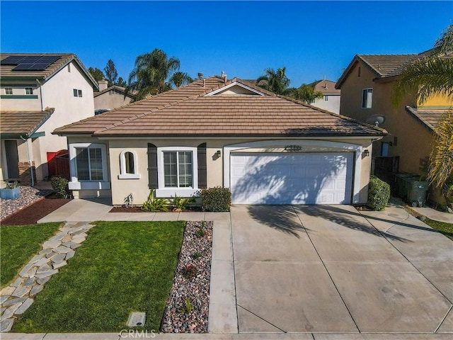 view of front of property featuring a tile roof, driveway, an attached garage, a front yard, and stucco siding