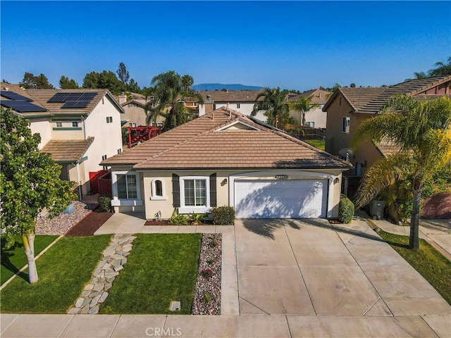 view of front of house with concrete driveway, an attached garage, a residential view, and a tile roof