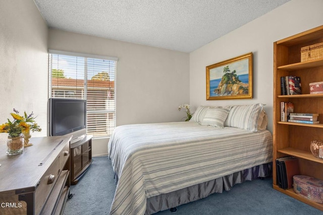 bedroom featuring dark colored carpet and a textured ceiling